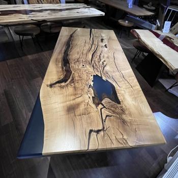 Ein besonderer Tisch mit guter Tradition, konservativ schön und grundtief lebendig durch masserungreiche Bergulme. Eine ganze Platte voller Leidenschaft veredelt durch einen tief blauen Epoxidharz auf einem Spider Gestell.